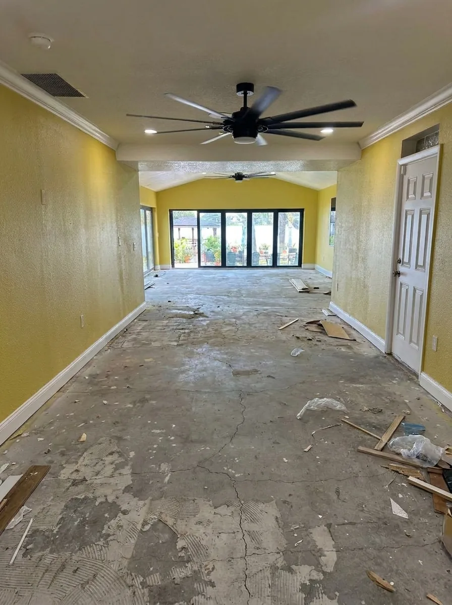 Living room with bare concrete subfloor before new flooring