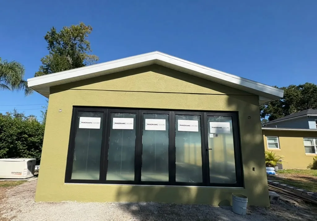Finished stucco building with new glass doors
